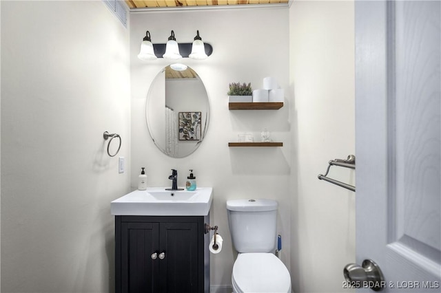 bathroom featuring vanity and toilet