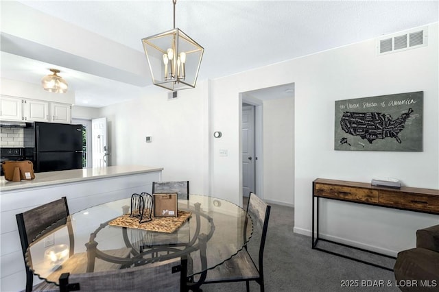 carpeted dining space with a notable chandelier