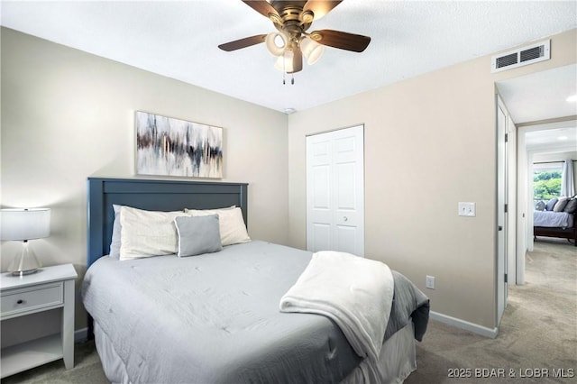 carpeted bedroom with a closet and ceiling fan