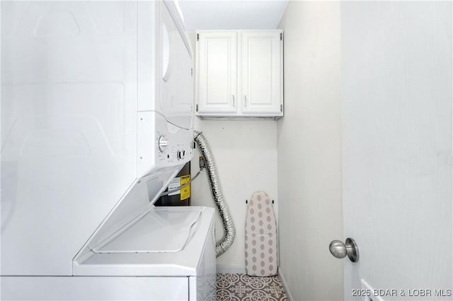 clothes washing area featuring stacked washer / drying machine