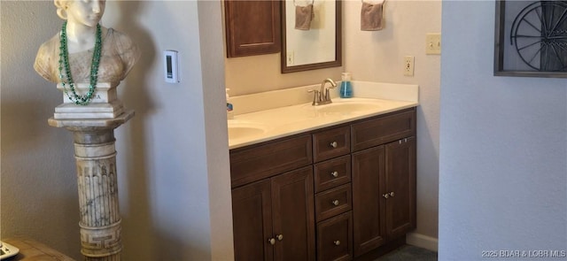 bathroom with a sink and double vanity