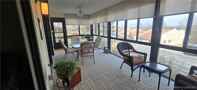 sunroom / solarium featuring a ceiling fan and a healthy amount of sunlight
