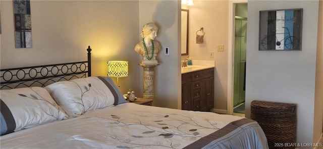 bedroom featuring ensuite bath and a sink