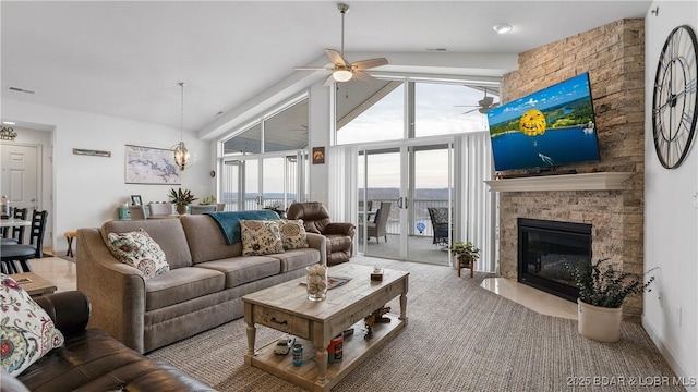 carpeted living room featuring a fireplace, high vaulted ceiling, and ceiling fan