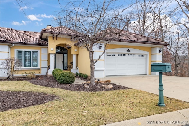 mediterranean / spanish-style home with a garage and a front lawn