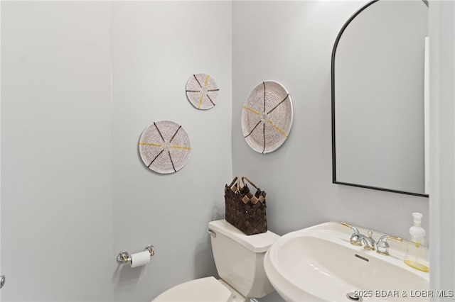 bathroom featuring toilet and sink