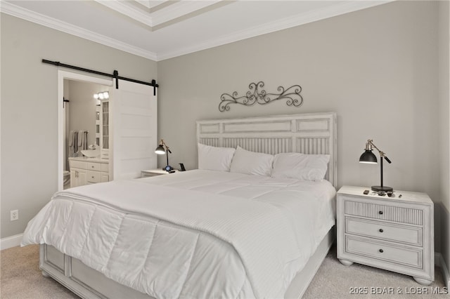 carpeted bedroom with ensuite bath, ornamental molding, and a barn door