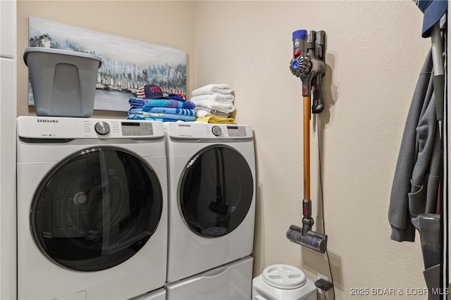 clothes washing area featuring washer and clothes dryer