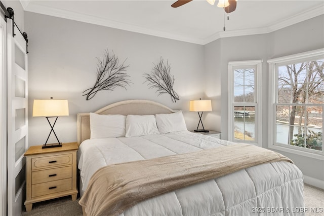 bedroom with multiple windows, crown molding, a barn door, and carpet floors