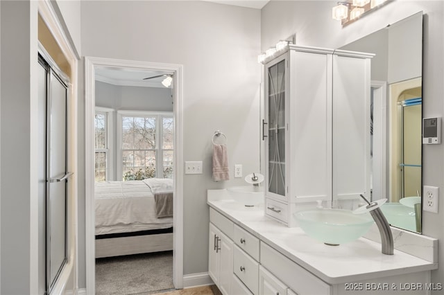 bathroom featuring vanity and an enclosed shower