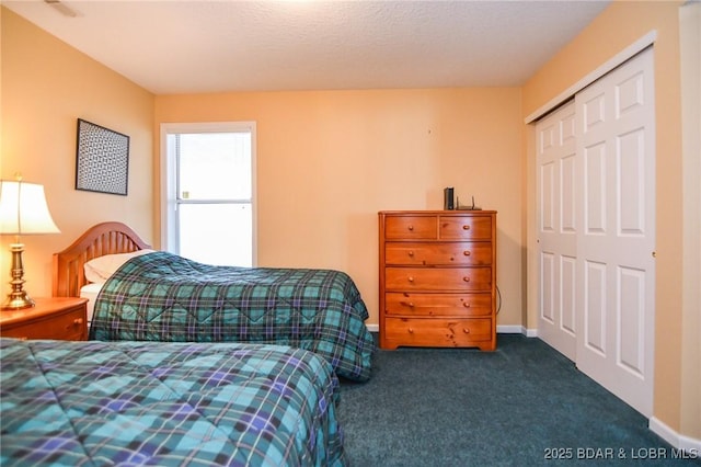 carpeted bedroom featuring a textured ceiling and a closet