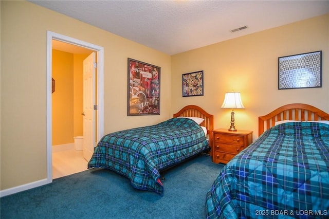 bedroom featuring carpet floors and a textured ceiling