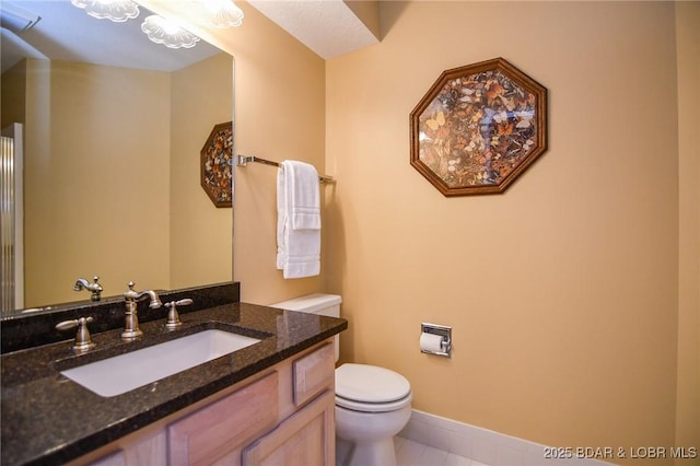 bathroom with vanity, tile patterned floors, and toilet