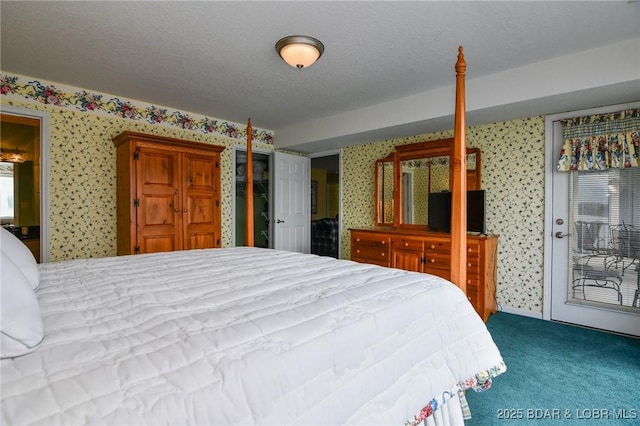 carpeted bedroom with access to exterior and a textured ceiling