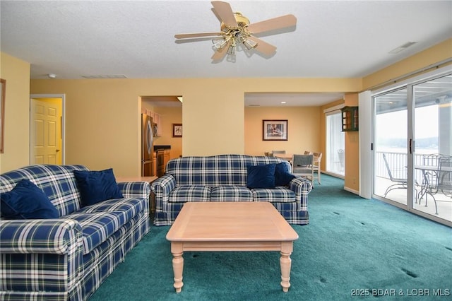 carpeted living room featuring ceiling fan