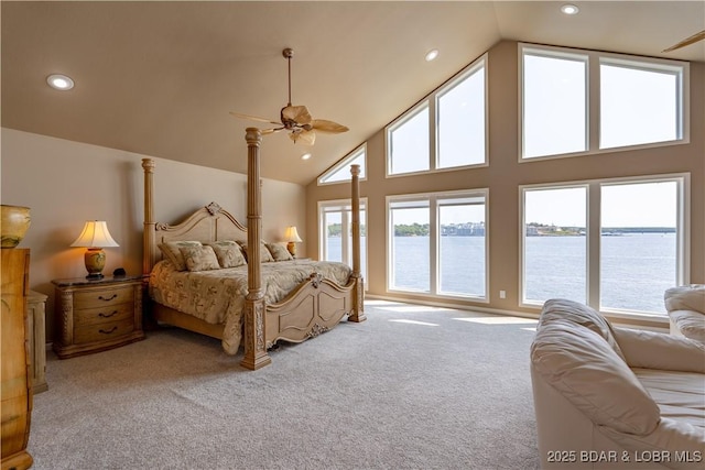 carpeted bedroom featuring a water view and high vaulted ceiling