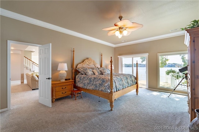 carpeted bedroom featuring a water view, ceiling fan, ornamental molding, and access to outside