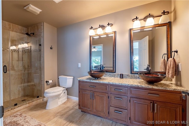 bathroom with vanity, toilet, and an enclosed shower