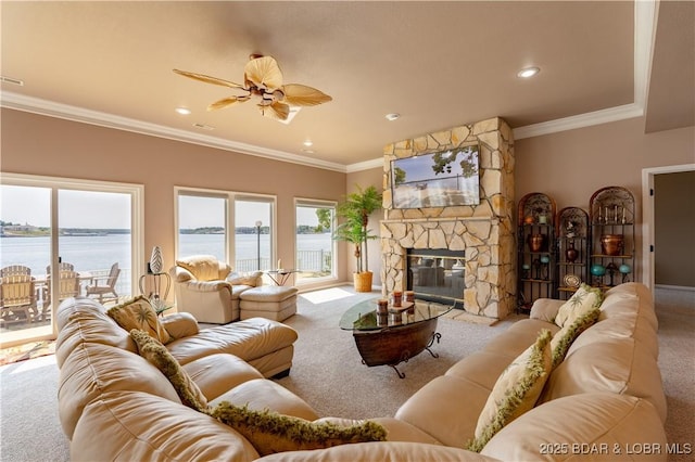 carpeted living room featuring crown molding, a fireplace, and ceiling fan