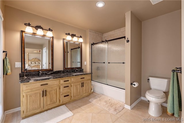 full bathroom featuring tile patterned flooring, enclosed tub / shower combo, vanity, and toilet