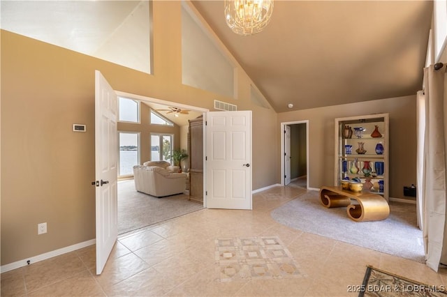 tiled foyer with an inviting chandelier and high vaulted ceiling