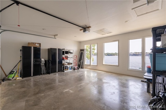 garage featuring a water view and a garage door opener