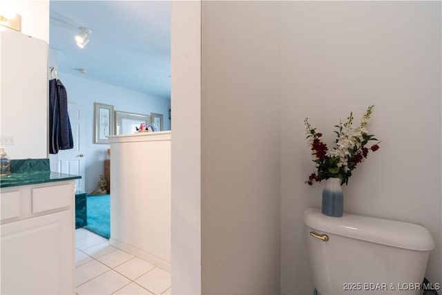 bathroom featuring vanity, toilet, and tile patterned flooring