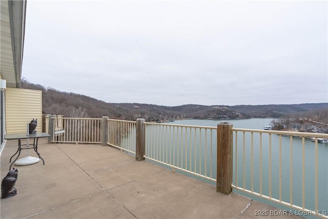 view of patio / terrace with a water and mountain view