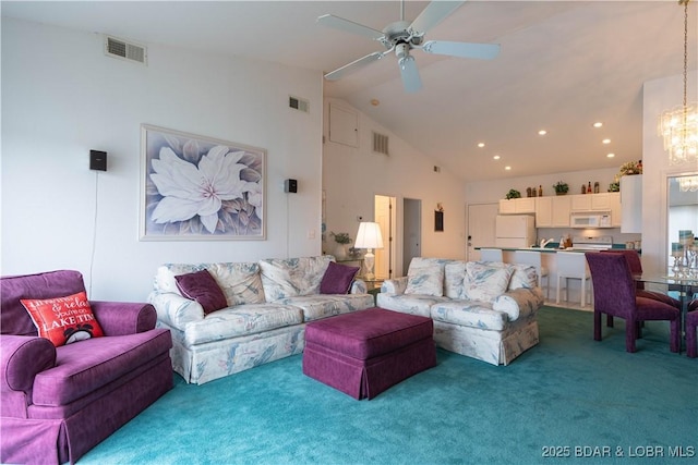 carpeted living room featuring ceiling fan with notable chandelier and high vaulted ceiling