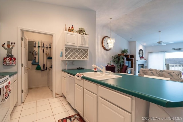 kitchen featuring sink, hanging light fixtures, light tile patterned floors, white appliances, and white cabinets