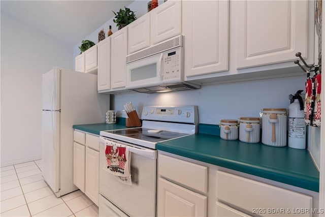 kitchen featuring light tile patterned floors, white appliances, and white cabinets