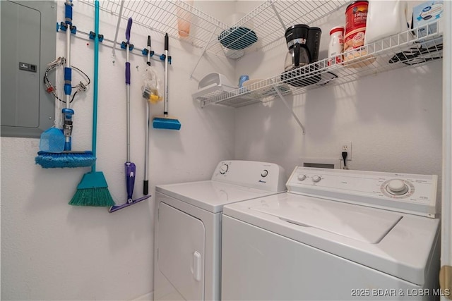 clothes washing area featuring separate washer and dryer and electric panel