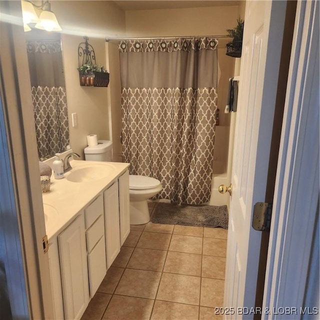 full bathroom with tile patterned flooring, vanity, shower / bath combo, and toilet