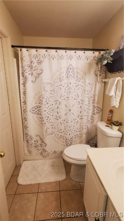 bathroom with tile patterned floors, toilet, and vanity