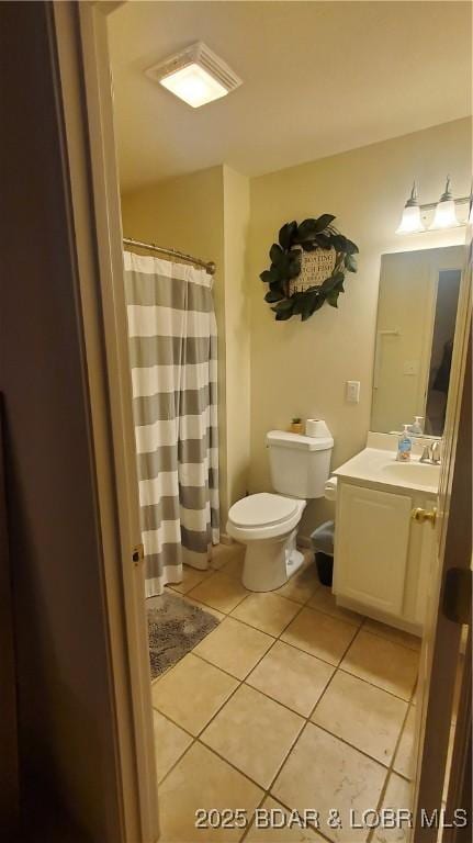 bathroom with vanity, tile patterned floors, and toilet