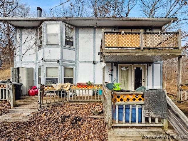 rear view of property featuring a balcony