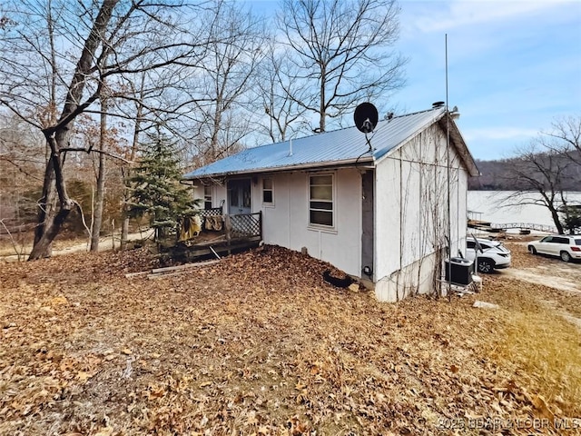 view of side of property featuring central AC