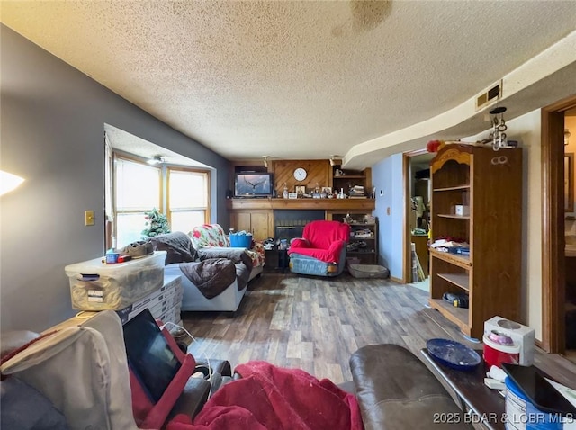 living room featuring hardwood / wood-style flooring and a textured ceiling