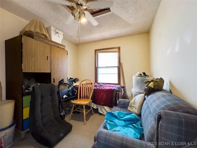 home office featuring ceiling fan, carpet, and a textured ceiling