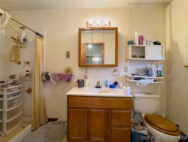 bathroom featuring vanity, curtained shower, a textured ceiling, and toilet