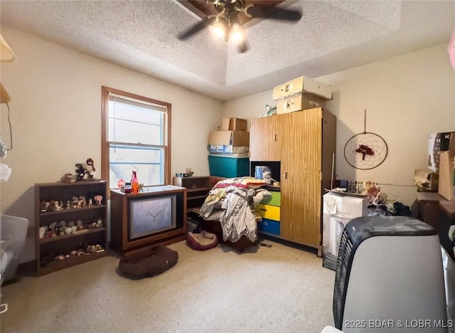 interior space featuring ceiling fan, light carpet, and a textured ceiling