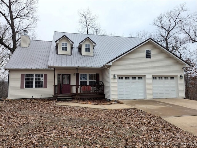 cape cod home featuring a garage and covered porch