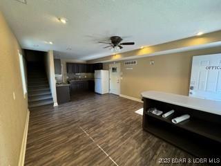 living room featuring ceiling fan and dark hardwood / wood-style flooring