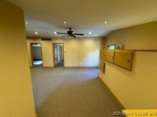 spare room with carpet floors and ceiling fan