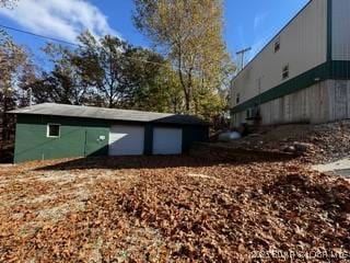 exterior space featuring a garage and an outdoor structure