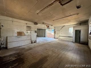 basement with hardwood / wood-style flooring