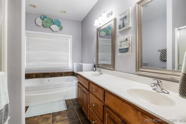 bathroom with vanity, tile patterned floors, and a tub to relax in