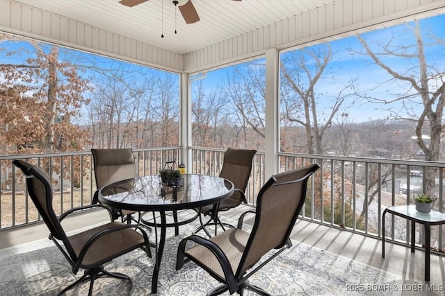 sunroom / solarium featuring ceiling fan