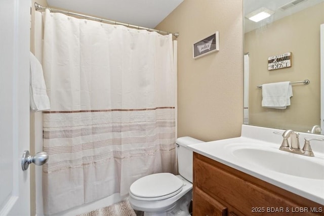 bathroom featuring walk in shower, vanity, and toilet