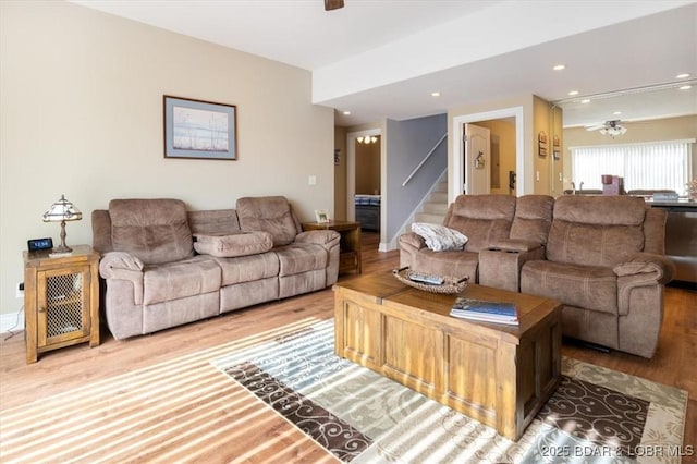 living room featuring hardwood / wood-style floors and ceiling fan